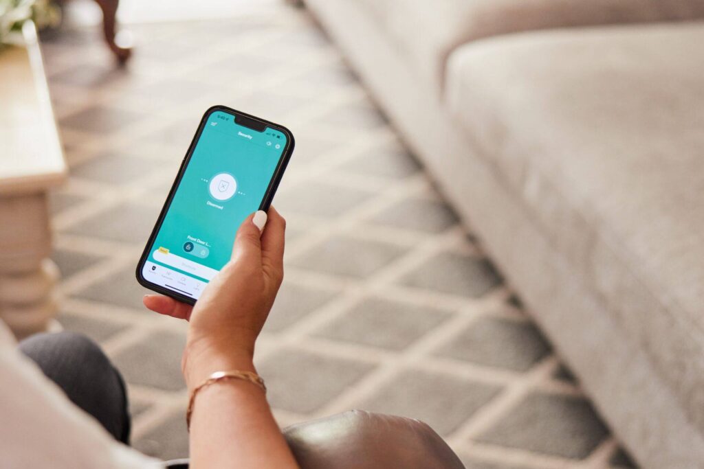 Close up view of a woman holding a mobile device.